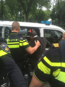 TPLF delegates being escorted by police in Rotterdam, Netherlands after their planned event was forcefully cancelled by Oromo protesters .