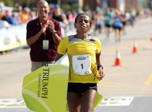 as-hirut-guangul-of-ethiopia-crossed-the-quad-cities-marathon-finish-line-as-the-first-woman-overall-for-the-fourth-consecutive-year-she-crossed-her-arms-above-her-head-in-an-x-p2