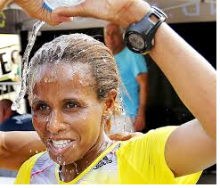 as-hirut-guangul-of-ethiopia-crossed-the-quad-cities-marathon-finish-line-as-the-first-woman-overall-for-the-fourth-consecutive-year-she-crossed-her-arms-above-her-head-in-an-x