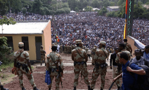 fascist-tplf-armed-security-forces-watch-as-protesters-stage-a-protest-against-government-during-the-irreechaa-cultural-festival-in-bishoftu-oromia-ethiopia-on-october-02-2016